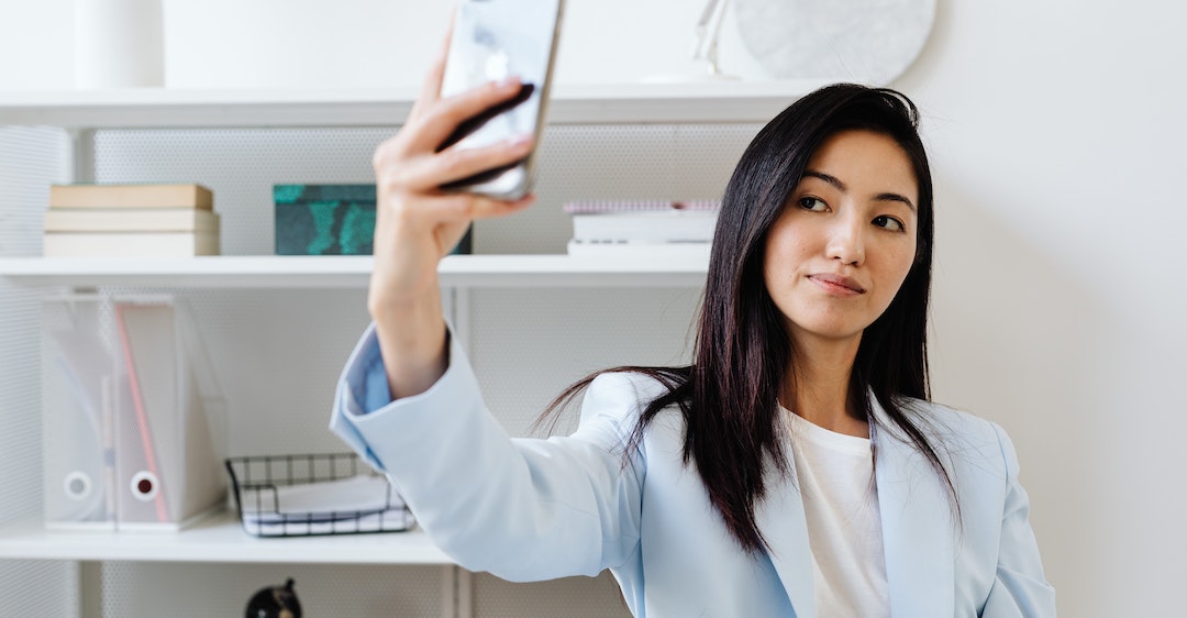 Female job candidate taking selfie for background check