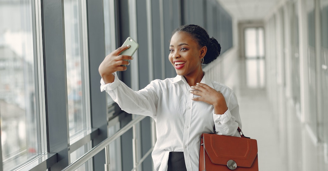 International business woman smiling taking selfie